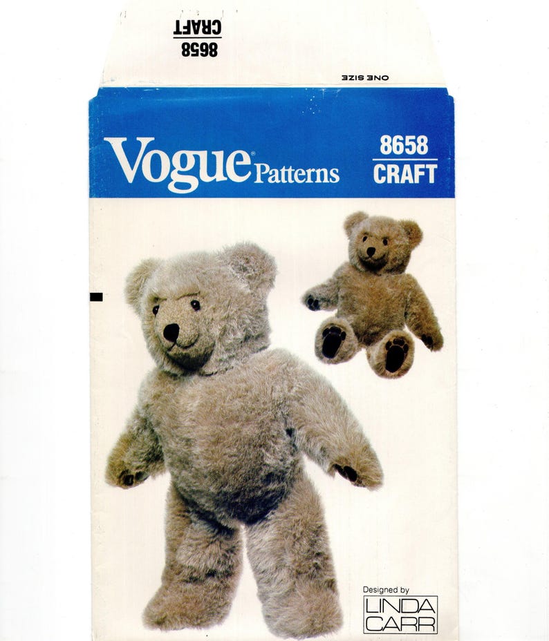 May include: Vogue Patterns craft pattern envelope featuring a teddy bear design. The envelope is white with a blue top section and the Vogue Patterns logo. The pattern includes instructions to create a plush teddy bear.