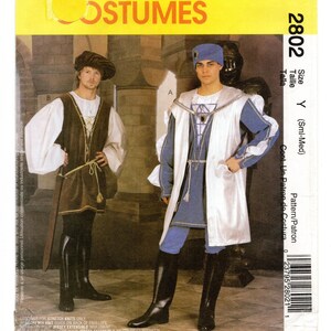 May include: A sewing pattern envelope labeled 2802 for costumes, featuring two outfits. One includes a brown tunic with white sleeves, a dark beret, and black boots. The other shows a blue tunic with a white overcoat, a blue cap, and black boots.