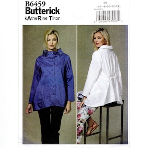 May include: Butterick sewing pattern B6459 by Katherine Tilton for a button-down shirt with a high collar. The pattern envelope displays a blue shirt and a white shirt with a pleated back detail, including size range 16-18-20-22-24.