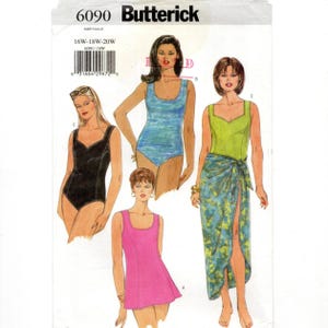 May include: A Butterick sewing pattern, number 6090, featuring illustrations of swimwear designs. The pattern includes a black swimsuit, a blue swimsuit, a pink dress, and a green top with a patterned sarong. Sizes 16W-18W-20W are included.