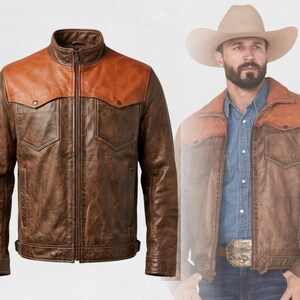 May include: A brown leather jacket with a contrasting orange yoke and two chest pockets. The jacket has a zip-up front and a classic western design. The jacket is shown on a white background.