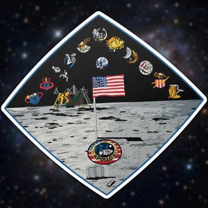 May include: A diamond-shaped sticker featuring an illustration of the Apollo 11 mission on the moon. The design includes the American flag, a lunar module, and various mission emblems against a starry background. The sticker has a white border.