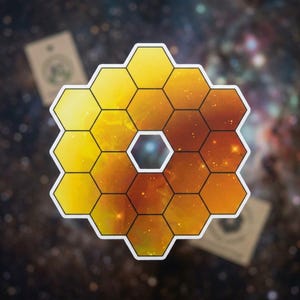 May include: A sticker featuring the James Webb Space Telescope's primary mirror, composed of golden hexagonal segments. The design showcases a cosmic background with stars and galaxies, and a white border.