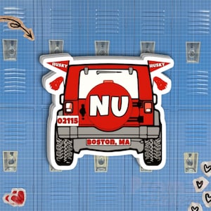 May include: A sticker featuring a red Jeep with the letters "NU" on the spare tire. The sticker also includes the text "HUSKY" and "BOSTON, MA" and the number "02115". The background is a blue locker.