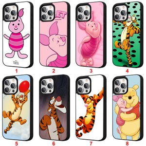 May include: A collection of eight phone cases featuring various characters from Winnie the Pooh. The cases showcase Piglet, Tigger, and Pooh in different poses and settings. Each case has a black border and a unique background color.