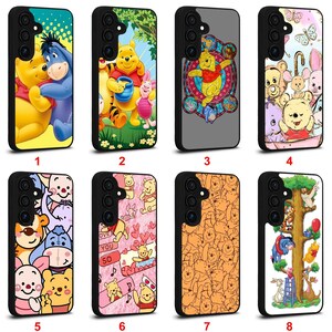 May include: A collection of eight phone cases featuring various designs of Winnie the Pooh and friends. The cases showcase different scenes and characters, with vibrant colors and detailed illustrations. Each case has a black border and a glossy finish.