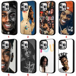 May include: Collection of eight black phone cases featuring images of a person. The cases display various portraits, including close-ups and full-body shots, with different backgrounds and poses. Some cases have text.