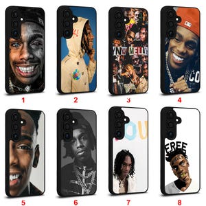 May include: A collection of eight black phone cases, each featuring a different image of a person. The images include portraits and graphic designs, with various color schemes and styles. The cases are designed for a smartphone.