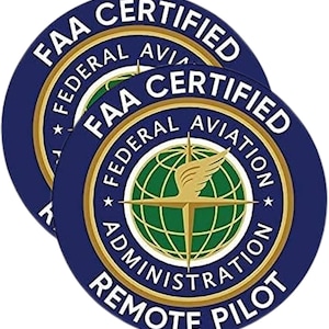 May include: Two circular FAA Certified Remote Pilot stickers. The stickers are navy blue with gold and white text. The center features a globe with a gold compass and wings.
