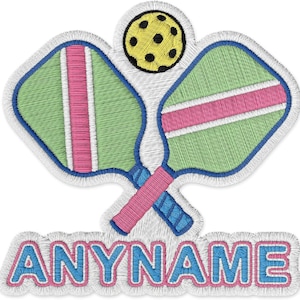 May include: Embroidered patch featuring two crossed pickleball paddles with green and pink details, a yellow pickleball, and the text "ANYNAME" in blue and pink. The patch has a white border.