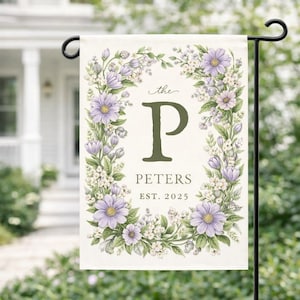 May include: A white ceramic mug with a colorful floral design. The mug features a handle and a wide opening. The flowers are in shades of pink, purple, and yellow. The mug is likely for hot beverages.