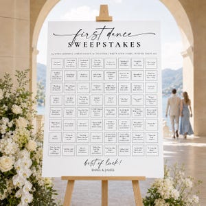 May include: A white wedding sign on a wooden easel titled First Dance Sweepstakes. It features a grid of song titles and artist names, with the text 64 SONG GUESSES, FIRST DANCE, TO ENTER, WRITE YOUR NAME, WINNER TAKES ALL, and best of luck! EMMA & JAMES.