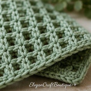 Close-up view of a handmade waffle stitch crochet dishcloth highlighting the textured stitch pattern.