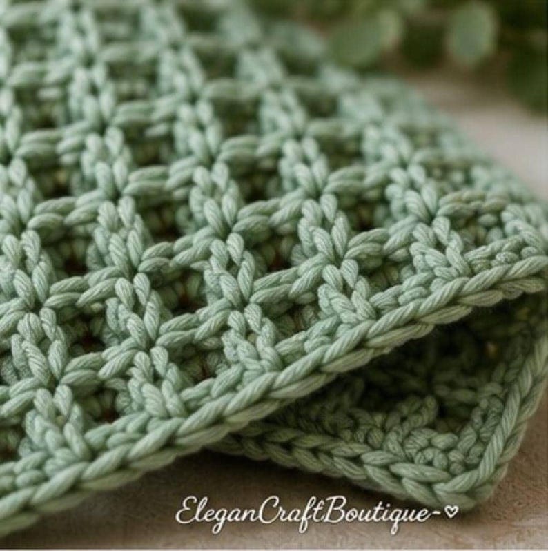 Close-up view of a handmade waffle stitch crochet dishcloth highlighting the textured stitch pattern.