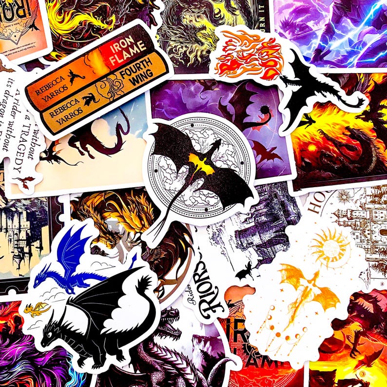 May include: A collection of fantasy-themed stickers featuring dragons in various colors and styles. Some stickers include text such as "IRON FLAME FOURTH WING" and "REBECCA YARROS". The stickers have a white border and are arranged on a surface.