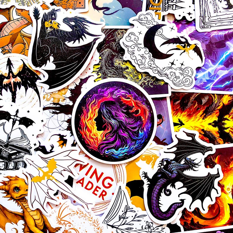 May include: A collection of fantasy-themed stickers featuring dragons, moons, and mystical imagery. The stickers showcase a variety of colors, including black, purple, orange, and yellow. One sticker has the text "WING READER".