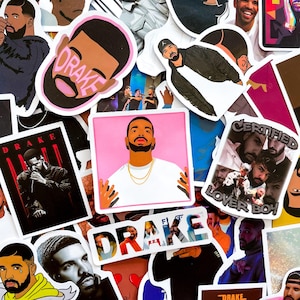 May include: A collection of colorful stickers featuring various images of Drake, including portraits, album art, and the word "Drake" in different fonts. The stickers are in various shapes and sizes, with a mix of illustrations and photographs.