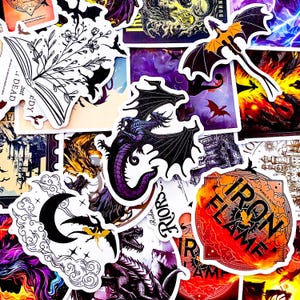 May include: A collection of fantasy-themed stickers featuring dragons, bats, and gothic imagery. The stickers showcase a variety of colors, including black, purple, orange, and white. Some stickers have text, including "IRON FLAME" and "Riders".