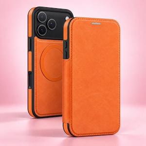 May include: A bright orange smartphone case with a folio cover and a matching orange back panel featuring a circular magnetic charging ring. The case has a black frame with cutouts for the camera lenses and side buttons, providing full protection.
