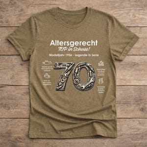 May include: A tan t-shirt with the text "Altersgerecht TOP in Schuss! Modelljahr 1956 - Legende in Serie." The number 70 is designed with gears and tools. Additional text and icons are also present.