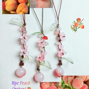 May include: Three peach-themed pendants with pink flower and leaf accents. Each pendant has a peach-colored stone at the bottom. The image includes photos of fresh peaches and the text "Ripe Peach Orchard".