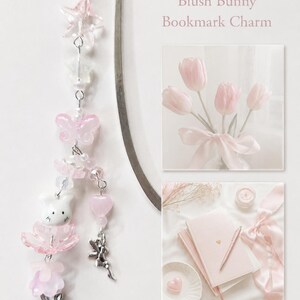 May include: A silver metal hook bookmark featuring a dangling charm strand with pink and clear beads, a white bunny bead, a pink butterfly, and a silver rabbit charm. The text Blush Bunny Bookmark Charm appears next to two images of pink tulips and stationery.