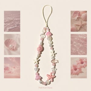 May include: A phone charm featuring a variety of pink, white, and clear beads, including shapes of seashells, starfish, flowers, and a fish. The charm is strung on a thin, light-colored cord and includes the text Pink Pearl Charm at the bottom.