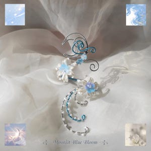 May include: A silver wire ear cuff featuring a crescent moon shape, two white and blue floral accents, and small white beads. The design includes swirling blue and silver wire elements. The text Moonlit Blue Bloom is printed at the bottom.