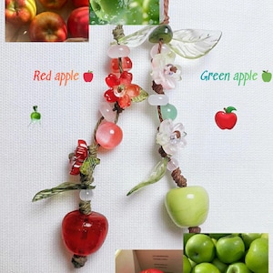 May include: A decorative apple-themed pendant with red and green apple charms, adorned with beads and floral accents. The image also includes photos of real red and green apples, with the text "Red apple" and "Green apple".