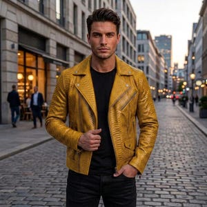 May include: A mustard yellow motorcycle jacket with a textured snakeskin pattern, featuring a wide notched collar, silver-toned metal zippers, and snap button details. The jacket is worn over a plain black t-shirt and dark-colored trousers.
