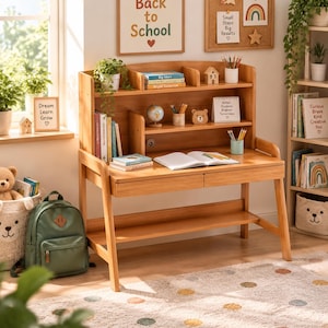 May include: A light-toned wooden desk featuring a hutch with multiple shelves, two drawers, and a lower storage shelf. The desk surface holds an open notebook, pencil holders, and books. The hutch contains a small globe and decorative items.