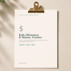 May include: A white printable money planner for kids held by a gold metal clip. The text reads: Printable Money Planner for Kids, Kids Allowance & Money Tracker, A simple, confidence-building way to help kids earn, save, spend and give with intention, Allowance, Savings, Chores, Ronitale Studio.