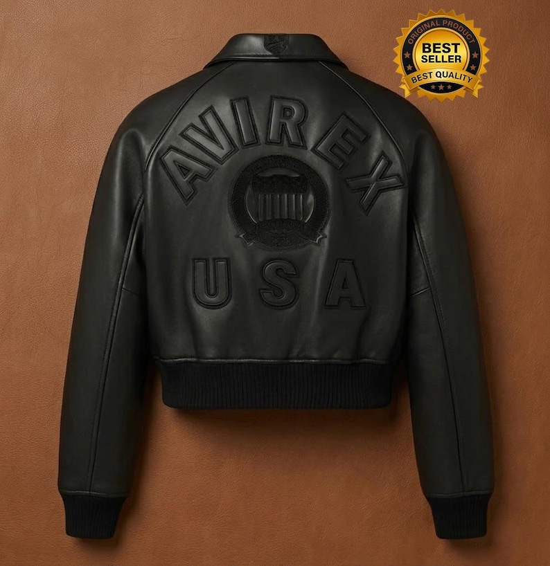 May include: Black leather bomber jacket with the word "AVIREX" and "USA" embossed on the back. The jacket has a ribbed hem and cuffs, a collar, and a "Best Seller" sticker.