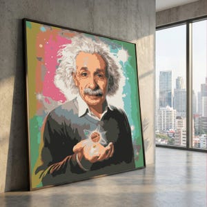 May include: A framed pop art style portrait of Albert Einstein. The artwork features Einstein with white hair and a mustache, holding a stylized atom. The background has colorful brushstrokes in pink, green, and orange. The portrait is leaning against a concrete wall.