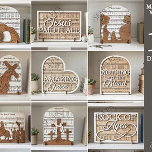 May include: A selection of ten wooden religious designs, each with a unique shape and message. The designs include phrases like "Jesus Paid It All" and "Amazing Grace," set against a backdrop of sheet music. The material width is 3mm.