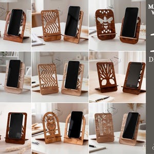 May include: A collection of ten wooden phone stands in various designs, including trees, geometric patterns, and an owl. Each stand holds a black smartphone. The material width is 3mm.