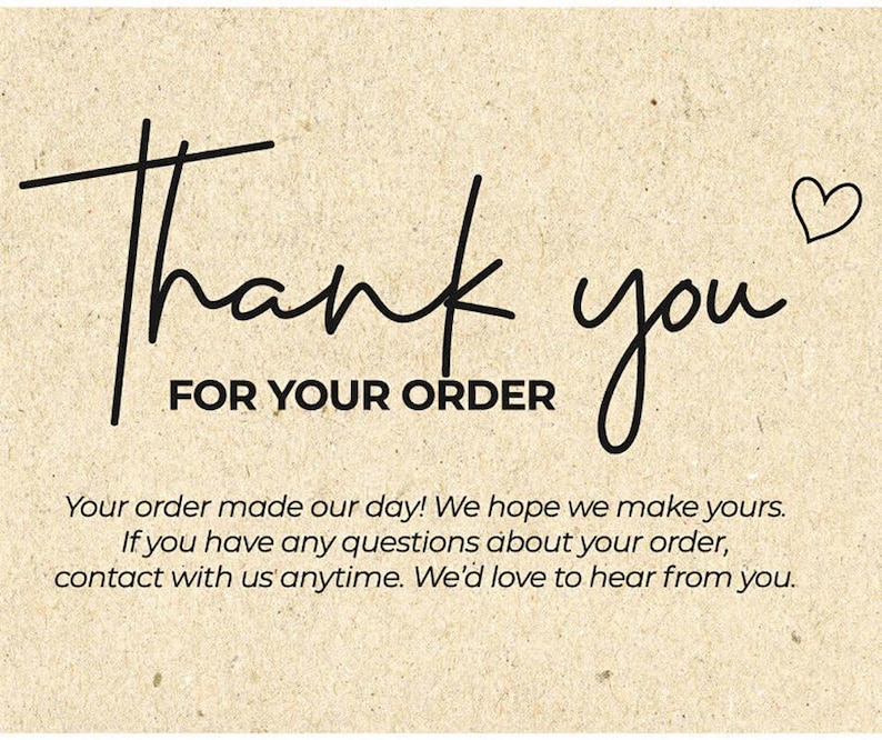 May include: A beige card with black handwritten text that says "Thank you FOR YOUR ORDER". A small heart is drawn next to the word "you". Additional text below the main message.