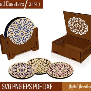 May include: Wooden boxed coasters with a laser-cut floral design. The set includes a holder and three individual coasters. The coasters have a light wood exterior with a blue and purple interior. The box has a matching floral design on the lid.