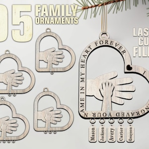 May include: Wooden heart-shaped family ornaments with a hand-holding design. The ornaments are laser-cut and feature the text "Engraved in my heart forever." Individual names are listed below. The image also shows the text "Laser Cut Files."