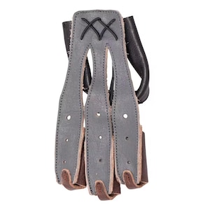 May include: A gray leather archery finger tab with three finger slots and brown leather accents. The finger tab has a black leather backing and is stitched with black thread. The top of the tab features a decorative criss-cross design.
