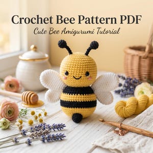 May include: A crochet bee amigurumi with a yellow and black striped body, white wings, and black antennae. The text reads Crochet Bee Pattern PDF Cute Bee Amigurumi Tutorial. The bee has black eyes and pink cheeks on a round yellow head.