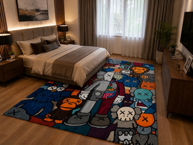 May include: A colorful, rectangular area rug with a cartoon character design in a bedroom setting. The rug features a variety of characters in shades of blue, orange, gray, and red. The bedroom includes a bed, dresser, and artwork.