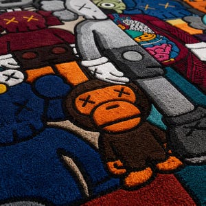 May include: A colorful, plush rug featuring a repeating pattern of cartoon figures in various colors. The figures have distinctive X-shaped eyes and crossbones. The rug's design includes shades of blue, red, orange, and gray.