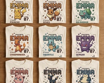 May include: A collection of nine off-white t-shirts, each featuring a pixel-art style graphic of a different creature. Every shirt displays the text 'TRAINER EMMA', 'LEVEL 07', and the name of the specific creature, including Pikachu, Eevee, Bulbasaur, Charmander, Squirtle, Gengar, Jigglypuff, Umbreon, and Snorlax.