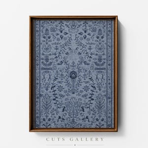 May include: A rectangular framed wall art piece featuring a light blue fabric background with a dark blue embroidered pattern of symmetrical floral and botanical motifs, enclosed in a thin, dark brown wooden frame with a clean, simple edge.