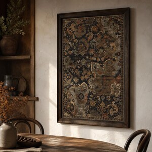 May include: A rectangular wall art piece featuring a dark, intricate floral and paisley pattern in shades of black, rust orange, muted blue, and cream, enclosed within a simple, dark brown wooden frame with a thin, textured border.