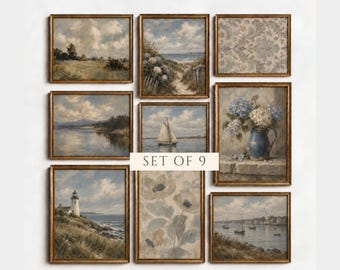 May include: A set of nine framed wall art prints featuring landscape, seascape, and floral paintings in muted blue, green, and beige tones. The collection includes images of a lighthouse, a sailboat, a blue pitcher with hydrangeas, and floral patterns.