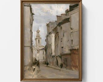 May include: An oil painting in a gold frame depicting a narrow European street scene with tall, muted gray buildings and a prominent church tower in the distance under a pale, cloudy sky. The artwork features visible brushstrokes.
