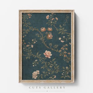 May include: A framed wall art print featuring a dark teal background with a repeating pattern of delicate, winding vines, green leaves, and soft peach-colored floral blossoms. The rectangular frame has a weathered, light-colored wood finish.