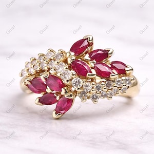 May include: A white ceramic mug with a black handle and the text "But First, Coffee" in a black, bold font. The mug is on a white surface.